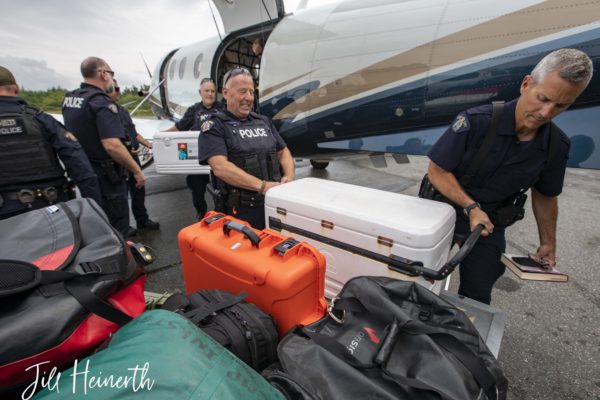 Unloading the plane in Bella Bella. Food coolers, personal gear and repair items are carefully weighted for the flight.