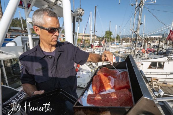 Constable Russ Warren grills some fresh salmon gifted to the crew from Constable Mike Reid's teenaged son.